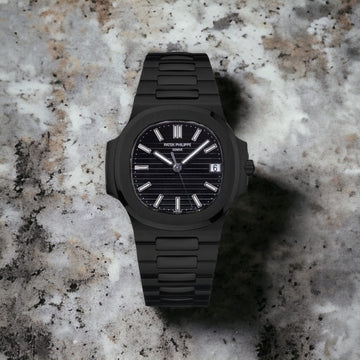 Nautilus watch with a black dial and a black band.